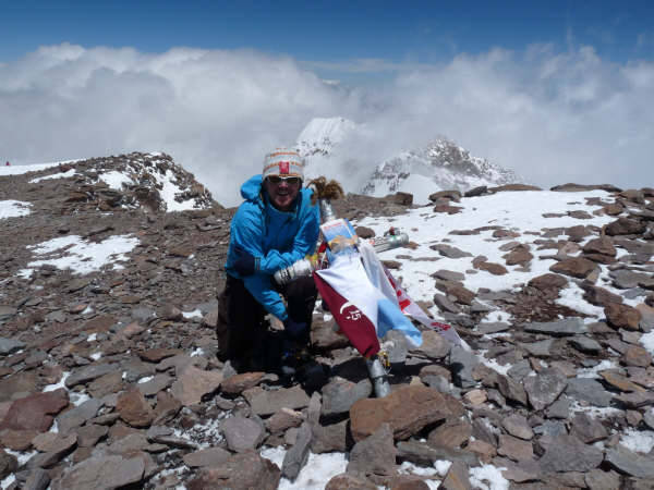 Gerrit Vrugdenhil on the summit of Aconcagua with the pocket Guidebook